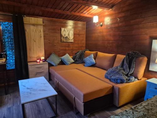 a living room with a couch in a room at Cabin39 in Barkingside
