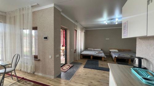 a living room with two beds and a table at Kapshagay Lake in Kapchagay