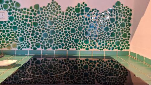 a bathroom with a bath tub with a mandala wall at Terrazza Tosti in Formia