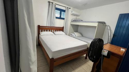 a small bedroom with a bunk bed and a window at Casa Marina in Beberibe
