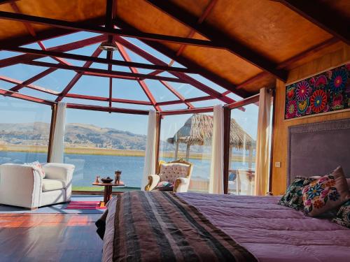 a bedroom with a bed and a view of the water at Titikala in Puno