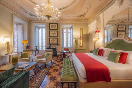 a bedroom with a large bed and a living room at Palazzo Trezza in Verona