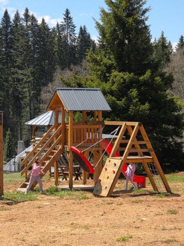 a group of children playing in a playground at Apartmani Suncani breg Tara in Mitrovac