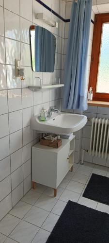 a bathroom with a sink and a mirror at Ferienwohnung Eckschlager in Kössen