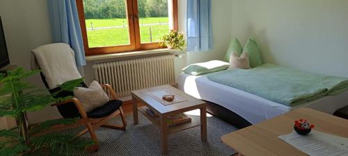 a small room with a bed and a table at Ferienwohnung Eckschlager in Kössen