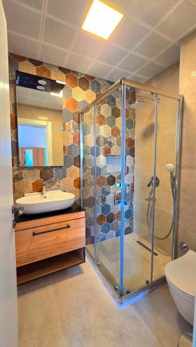 a bathroom with a glass shower and a sink at Bozburunvillas in Bozburun