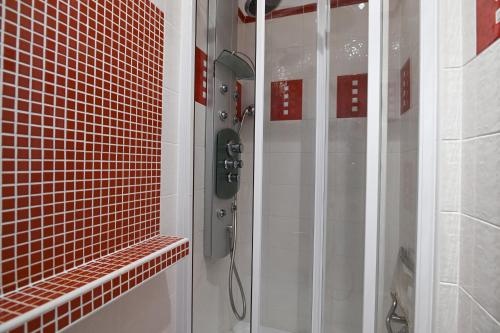 a bathroom with a shower with a phone in it at Sowa Rigpa apartmán in Gerlachov