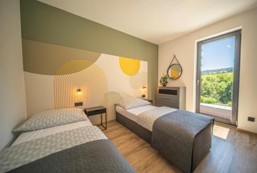 a hotel room with two beds and a window at RosoChata313 Domek w górach z Sauną,Jacuzzi,Basenem "Panieński" ruska Bania na wyłączność in Mogilno