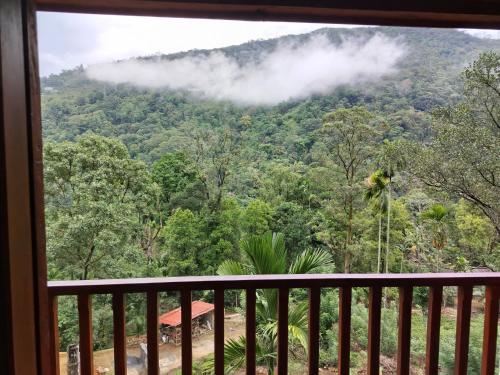 a room with a view of the mountains from a balcony at Wishparing fall villa laxapane in Kiriwan Eliya