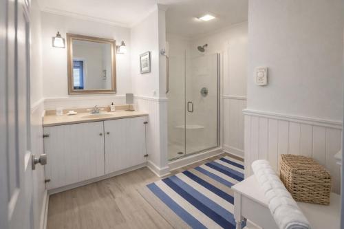 a white bathroom with a sink and a shower at The Trellis House in Ogunquit