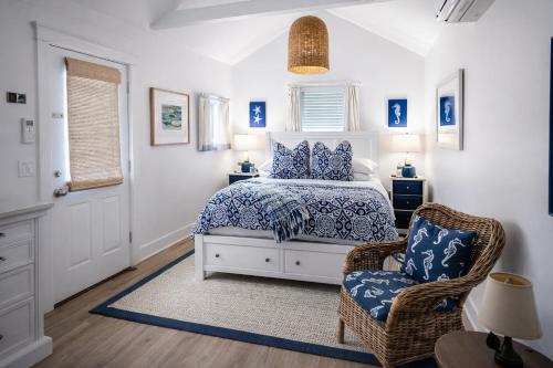 a bedroom with a bed and a chair at The Trellis House in Ogunquit