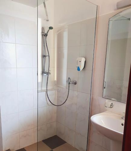 a bathroom with a shower and a sink at Hotel Angely in Eforie Nord