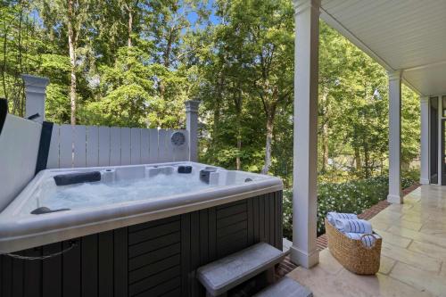 a jacuzzi tub on a patio with at The Sinclair House Private Lake Retreat in Milledgeville