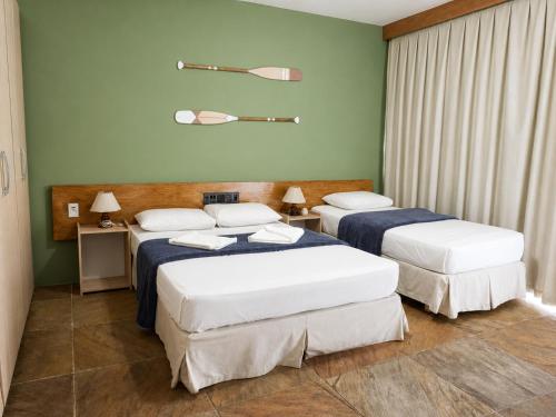 a room with two beds in a room at HANNA Marina's Palace Hotel in Florianópolis