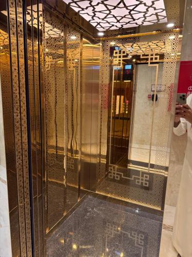 a woman taking a picture of a elevator in a building at أوركيد بالاس للشقق المخدومة in Riyadh