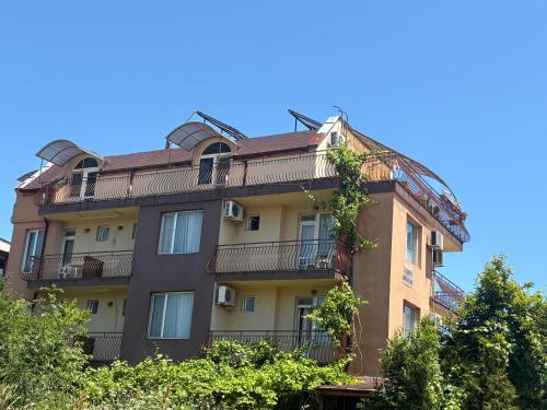 an apartment building with a roof at Miraj-MD in Primorsko