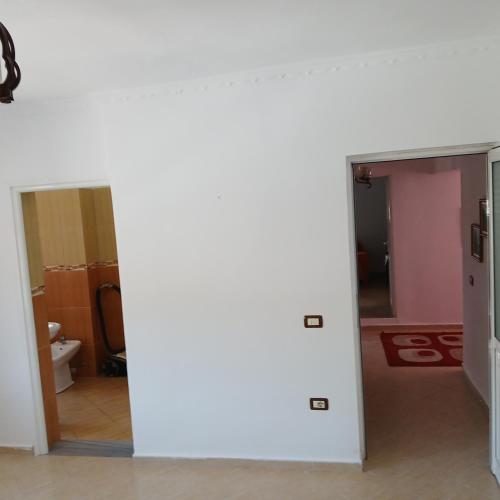 an empty room with a bathroom with a toilet at Johnny Apartment Berat in Berat