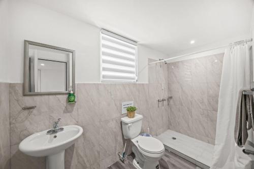 a bathroom with a toilet and a sink and a shower at Downtown Studio at San Juan JL Guaynabo in San Juan