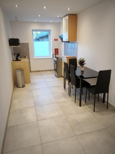 a kitchen and dining room with a table and chairs at Villa Serenita in Montenau