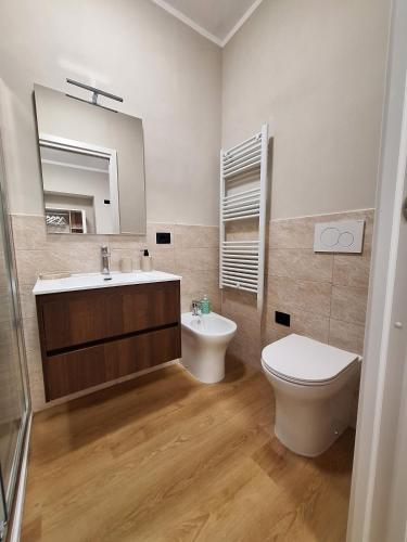 a bathroom with a sink and a toilet and a mirror at La Giara in Spoleto