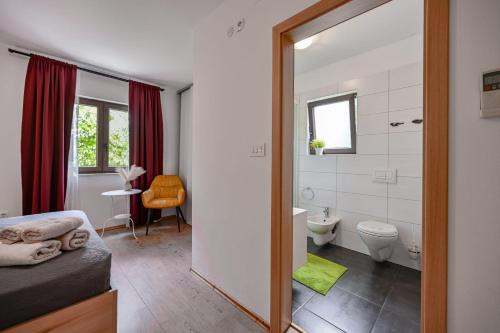 a bathroom with a shower and a toilet and a sink at Villa Ferlini in Ferlini