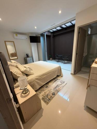 a bedroom with a bed and a room with a table at Las Lilas - 102 in Cali