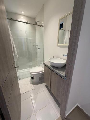 a bathroom with a sink and a toilet and a shower at Las Lilas - 102 in Cali