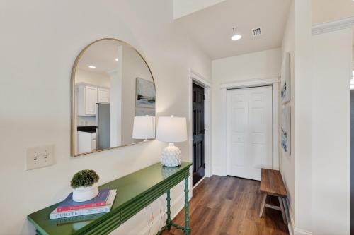 a hallway with a mirror and a green console table at Sea Gate 303 in Saint Simons Island