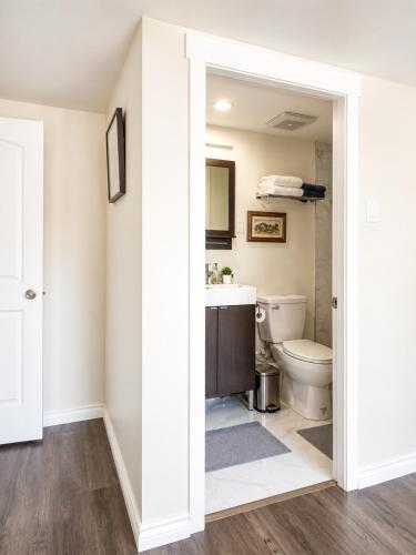 a bathroom with a toilet and a sink at Cozy Coastal Retreat Close to Beach Park in Port Moody