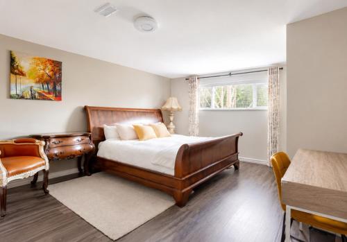a bedroom with a bed and a chair and a window at Cozy Coastal Retreat Close to Beach Park in Port Moody