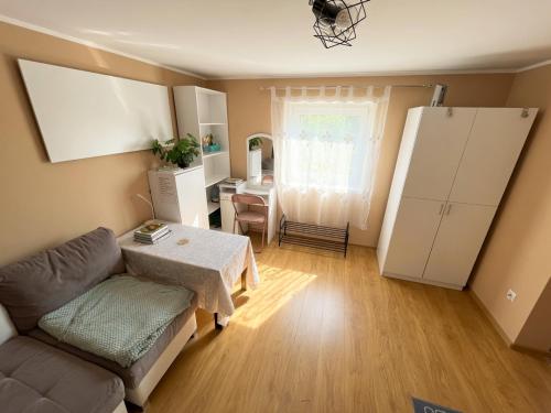 a living room with a couch and a table at Kamienica Partyzantów in Pasłęk