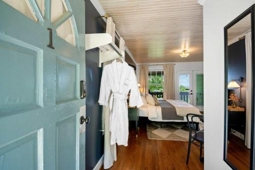 a white robe hanging on a door in a bedroom at Historic Riverview Inn One in Chattanooga