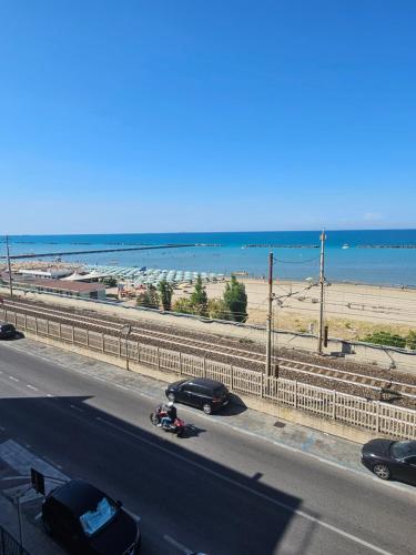 a highway with cars parked on the side of a beach at palombina vista mare in Ancona