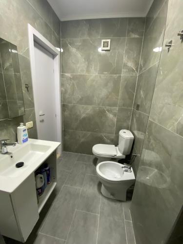 a bathroom with a toilet and a sink at Beachfront Apartment Durres in Durrës