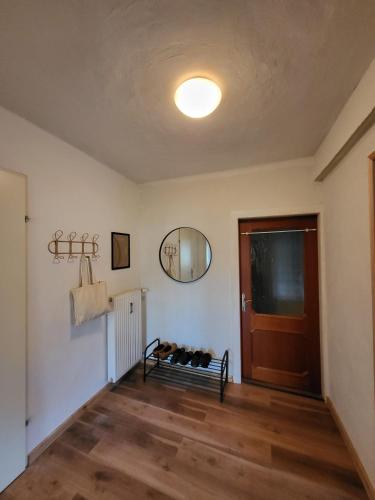 a living room with a door and a mirror at Studio in Fürstenfeld