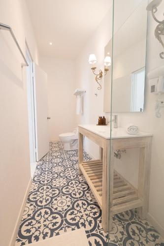 a bathroom with a sink and a toilet at Cabrero House Boutique in Cartagena de Indias