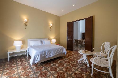 a bedroom with a bed and a table and chairs at Cabrero House Boutique in Cartagena de Indias