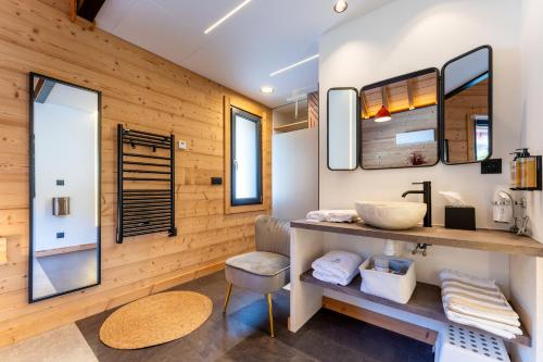a bathroom with a sink and a mirror at EPIC CHALETS - 4 et 5 étoiles - Spa privatif - Gérardmer in Granges-Aumontzey