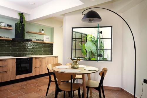 a kitchen with a table and chairs and a window at Cotto Apartment in Agios Nikolaos