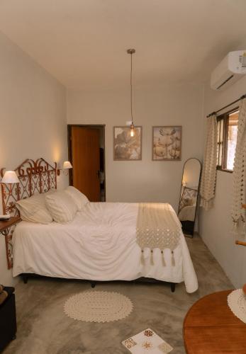 a bedroom with a large white bed in it at Chale Selah Gameleiras in Monte das Gameleiras