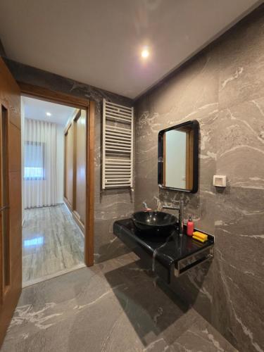 a bathroom with a black sink and a mirror at Villa Sunrise in Hammamet