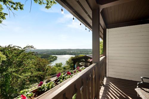 a balcony with flowers and a view of a river at Historic Riverview Inn Four in Chattanooga