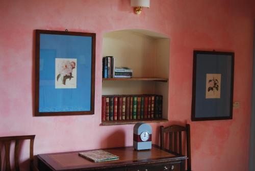 a room with a desk with a book shelf and a mirror at Antica Dimora Firenze in Florence