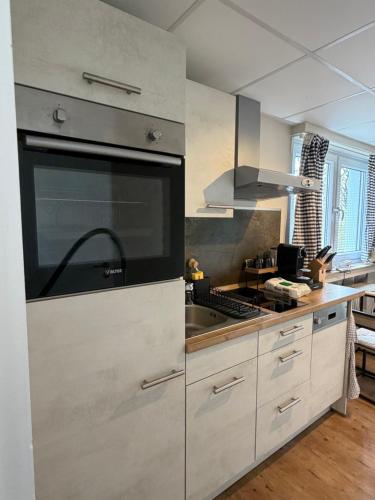 a kitchen with a sink and a stove top oven at Apartment Landglück Overath in Overath