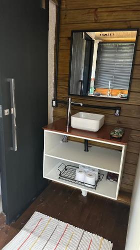 a bathroom with a sink and a mirror at Sunrise in Domingos Martins