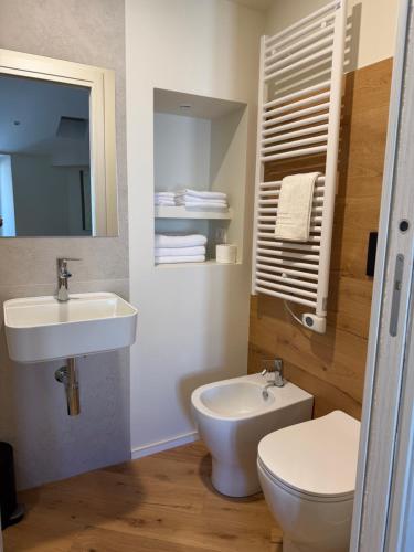 a bathroom with a white toilet and a sink at Casa Picicio in Assisi