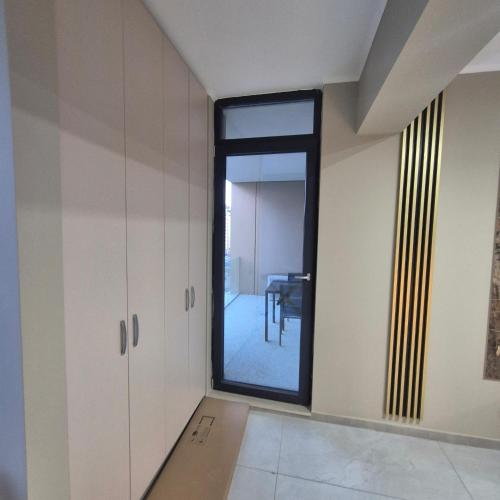 a empty room with a window and a table at Dana Residence in Floreşti