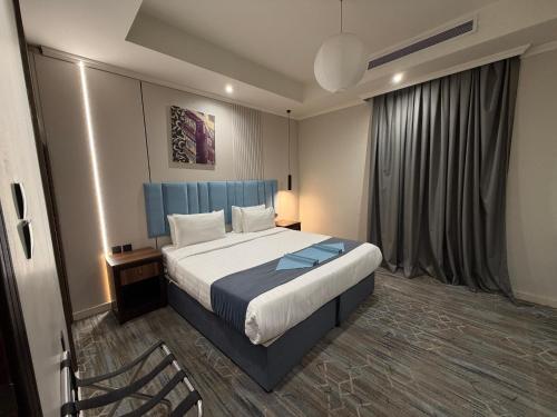 a hotel room with a bed and a chair at Akarem New - Al Safa - اكــارم - الصفا in Jeddah