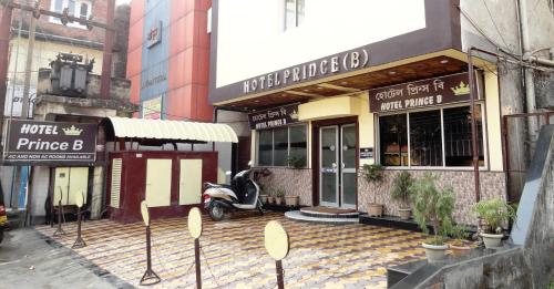 a street with a scooter parked in front of a building at Hotel Prince B in Guwahati