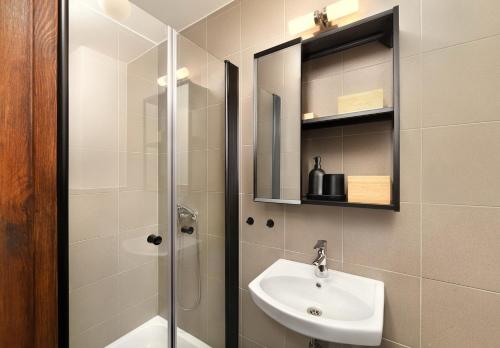 a bathroom with a sink and a shower at Apartmany Izbica in Červený Kláštor